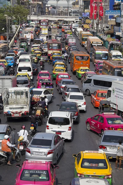 Traffic moves slowly along a busy road in Bangkok, Thailand.