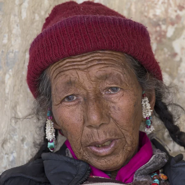 Tibetan old woman during mystical mask dancing Tsam mystery dance in time of Yuru Kabgyat Buddhist festival at Lamayuru Gompa, Ladakh, North India