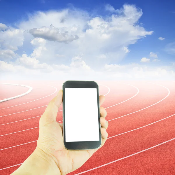 Hand holding smart phone at curve of a running track