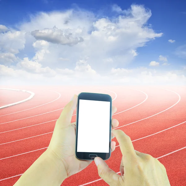 Hand holding smart phone at curve of a running track