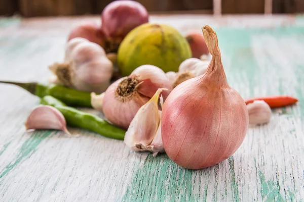 Organic red onion garlic and lemon on wooden background