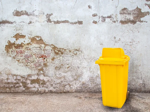 Yellow garbage bins on grunge background