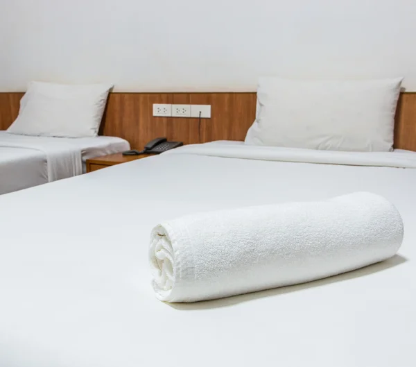 White bed and towels on the bed