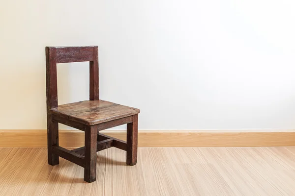 Old wooden chair on laminate flooring