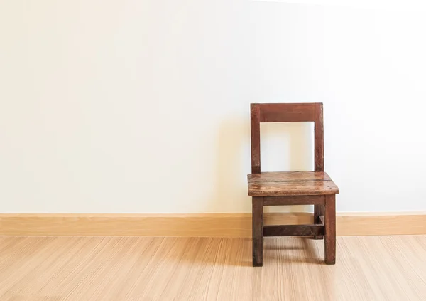 Old wooden chair on laminate flooring