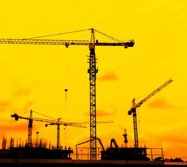 Construction site crane silhouettes