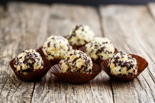 Delicious vegetarian truffle candies on wodden table.