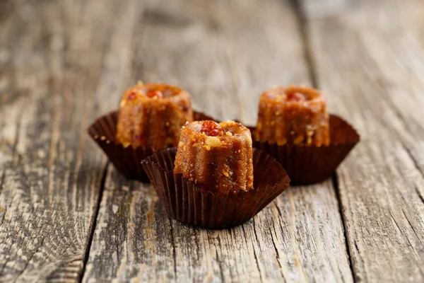 Delicious vegetarian candies anthill on wooden table for snack.