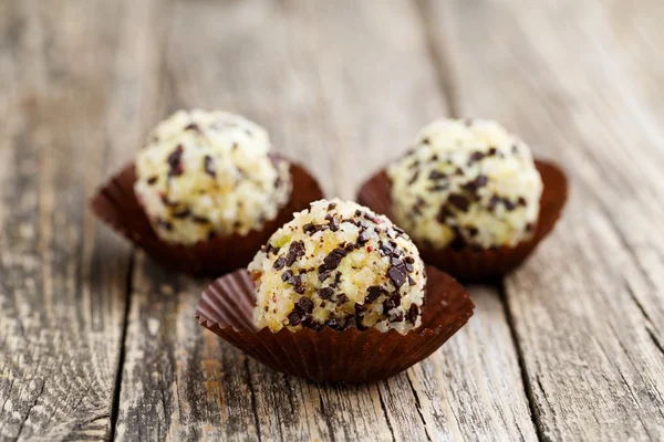 Delicious vegetarian truffle candies on wodden table.