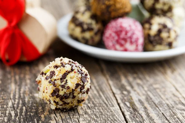 Delicious vegetarian truffle candies on wodden table.