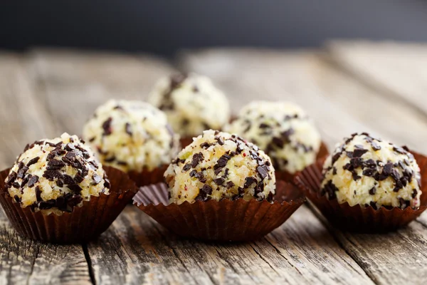 Delicious vegetarian truffle candies on wodden table.