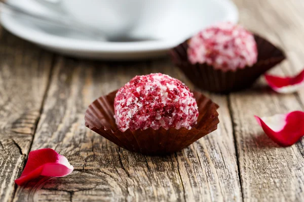 Delicious vegetarian truffle candies on wodden table.