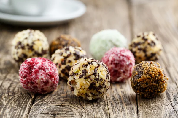 Delicious vegetarian truffle candies on wodden table.