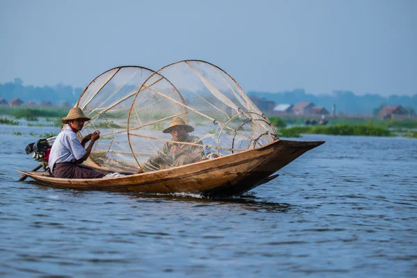 Mandalay - October 15: Fishermen catch fish Oct 15, 2014 in Mandalay. Fishermen show ancient way of fishing nets