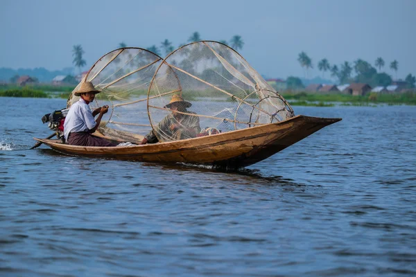 Mandalay - October 15: Fishermen catch fish Oct 15, 2014 in Mandalay. Fishermen show ancient way of fishing nets