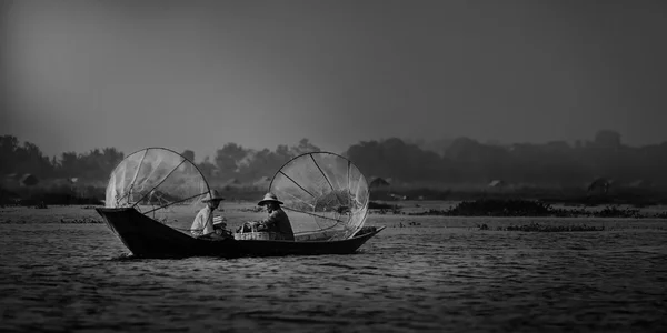 Mandalay - October 15: Fishermen catch fish Oct 15, 2014 in Mandalay. Fishermen show ancient way of fishing nets