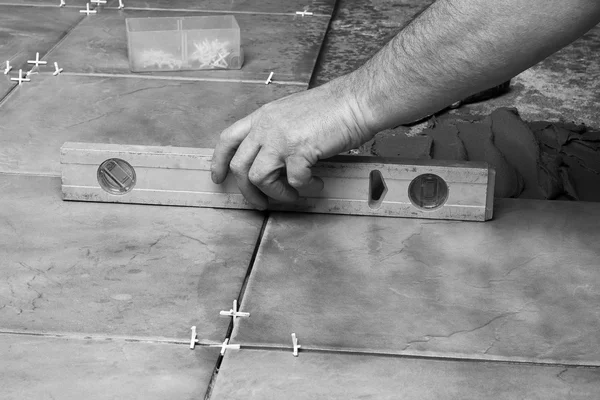 Renovation - construction worker laying tile