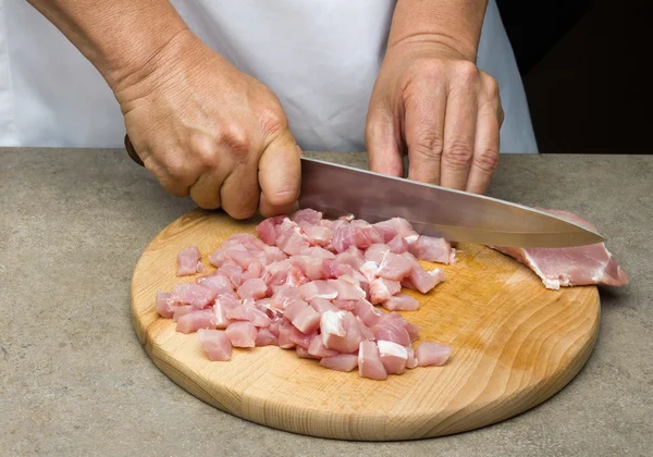 Hands of a man preparing meat
