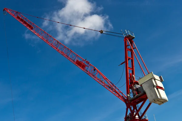 Fixed tower crane for construction against a blue sky
