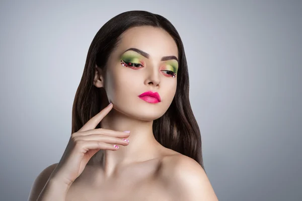 Fashion portrait of a young beautiful girl with bright makeup.