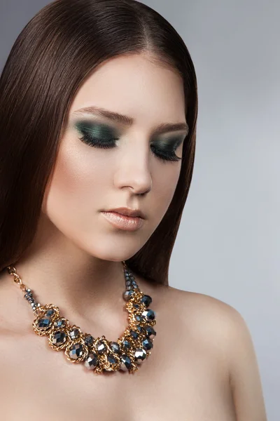 Portrait of a young beautiful girl with a professional make-up. Luxury perfect hair. Bright makeup.