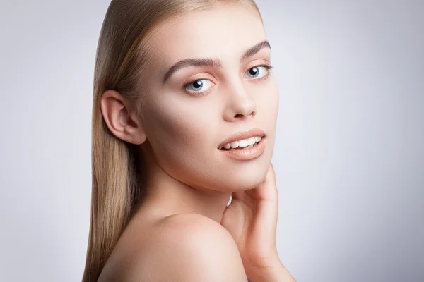 Portrait of a young beautiful blue-eyed girl. Beautiful make-up, perfectly smooth hair, blue eyes, open arms, perfect skin.