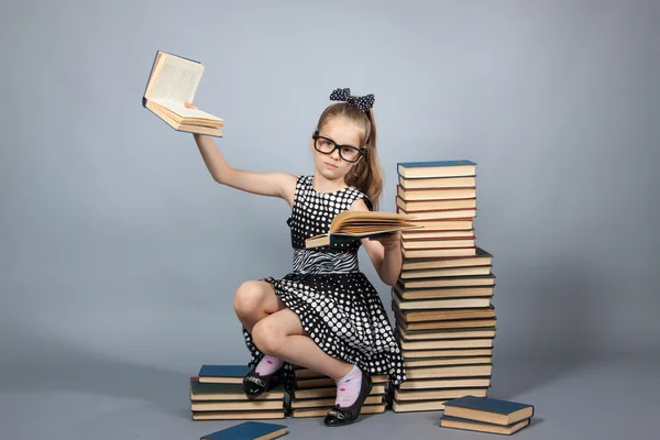 Smart girl with a stack of books.