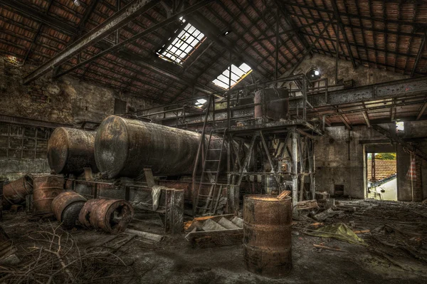 Rusty cisterns and barrels in an abandoned factory