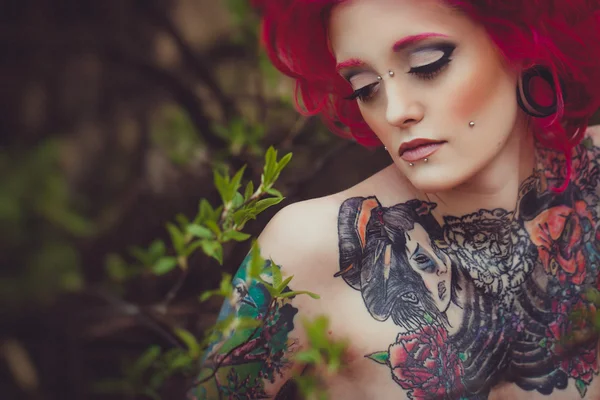 Portrait of tattooed girl with pink hair