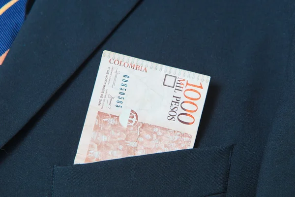 Colombian Pesos in the pocket of a suit