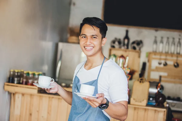 Waiter serving coffee