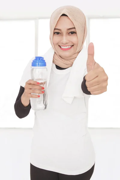 Woman holding bottle of mineral water