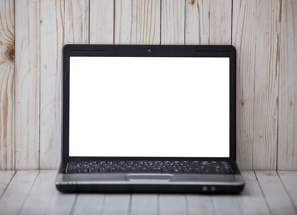 Black laptop on the wall and wooden background
