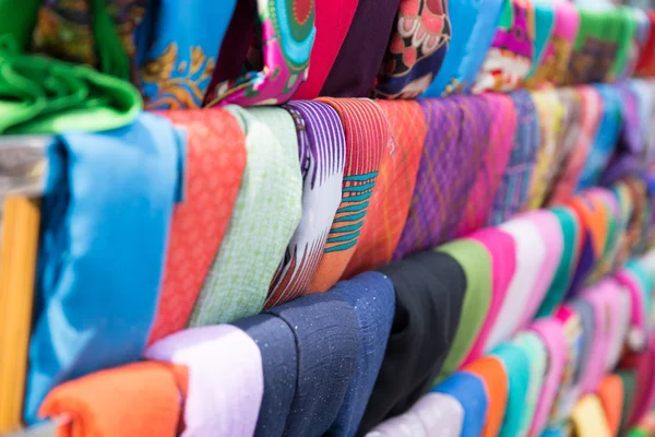 The colored scarfs in rows in market