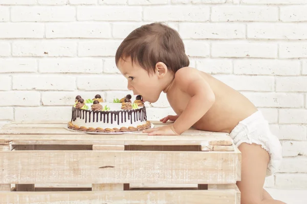 Cute toddler eating his cake