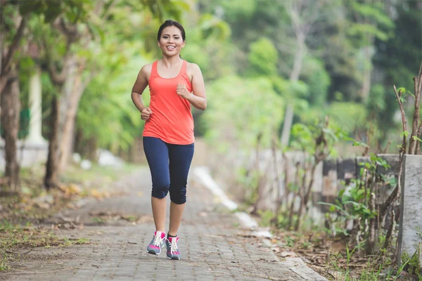 Young Asian woman jogging at park
