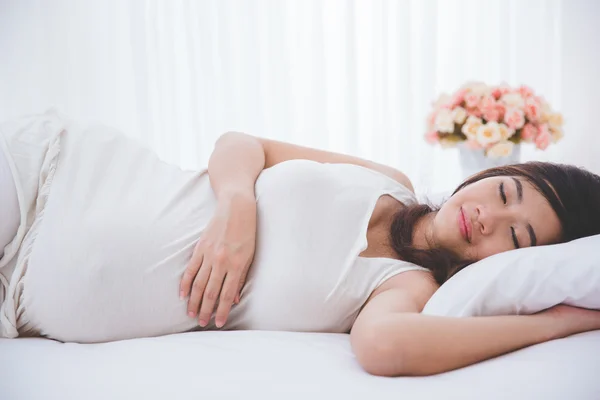 Pregnant asian woman sleeping peacefully