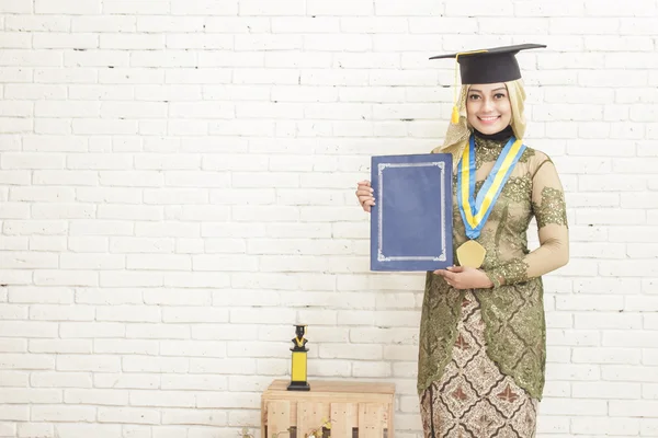 Indonesia female graduated student wearing traditional clothes