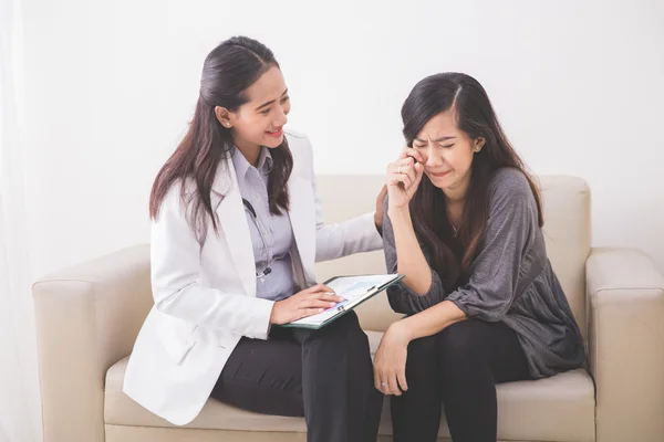 Asian patient consulting with doctor