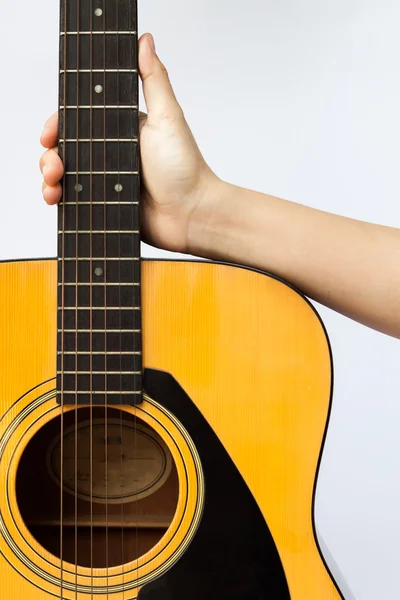 Woman's hand holding acoustic guitar on white background