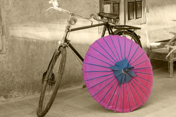 Retro bicycle with red umbrella with vintage style