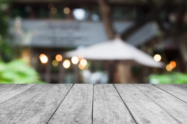 Black and white wooden table top with cafe background