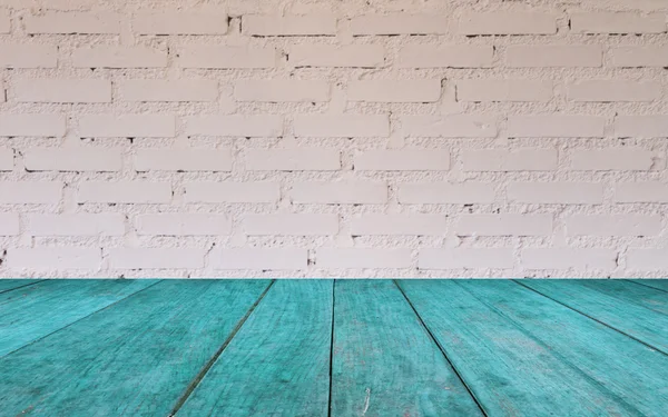 Blue wooden table top with brick wall