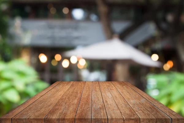 Perspective wooden table top with cafe background
