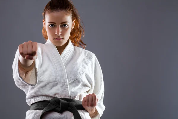 Karate Woman Throwing a Punch