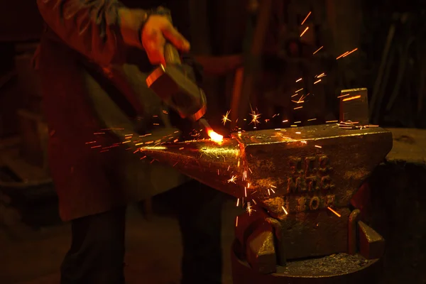 Blacksmith forfing hot iron