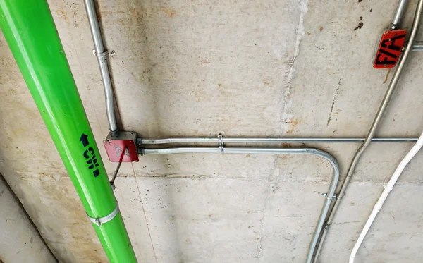 Green water pipes installed on the cement ceiling