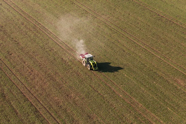Aerial view of harvest fields with tractor