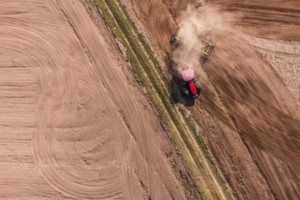 Aerial view of of tractor on harvest field