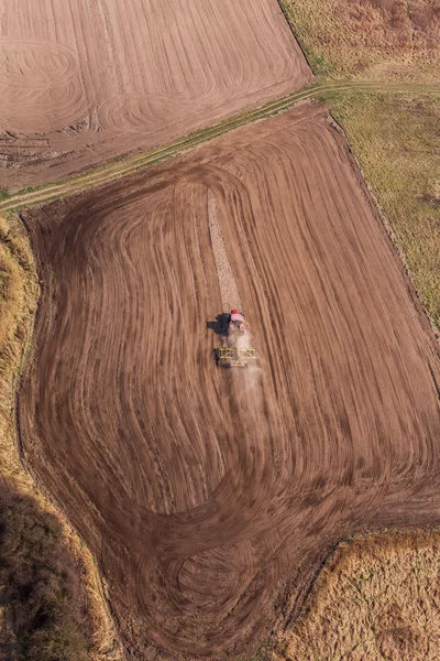 Aerial view of of tractor on harvest field